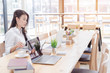 © PRIME STOCK LAB - Happy asian business woman working with laptop in co-working.