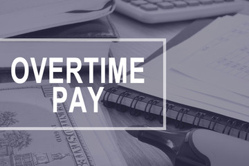 Overtime pay. Office desk with calculator and documents.