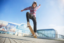 Skateboarder Makes Jump Trick On Board Against Sunset