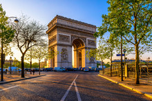 Paris Arc De Triomphe (Triumphal Arch) In Chaps Elysees At Sunset, Paris, France.