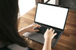 © Suradech - Women using laptop with blank screen at table in the office