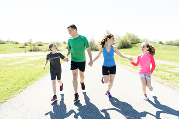 Parents with children sport running together outside