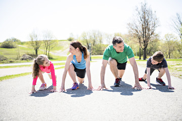 Parents with children sport running together outside