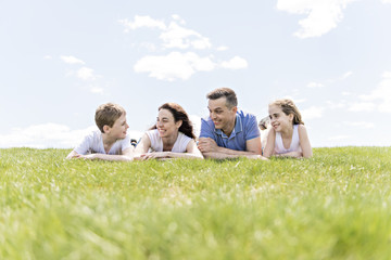 Wall Mural - Family of four outdoors in a field having fun