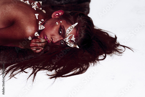 Female Demon With Red Skin And Horns On Head Lying On Floor