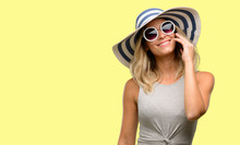 Young Woman Wearing Sunglasses And Summer Hat Happy Talking Using A Smartphone Mobile Phone