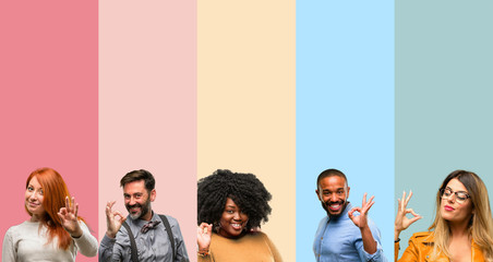 Canvas Print - Cool group of people, woman and man doing ok sign with hand, approve gesture