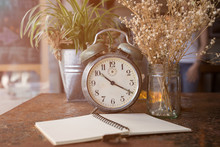 Retro Clock And Note With White Flower Placing On Rusty Table