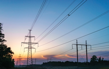 Silhouette High voltage electric tower on sunset time and sky on sunset time background.