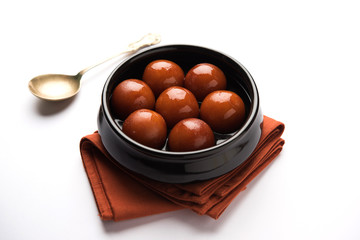 sweet gulab jamun in terracotta bowl