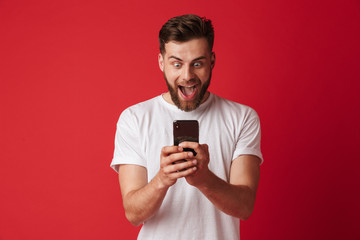 Canvas Print - Shocked screaming young man using mobile phone.