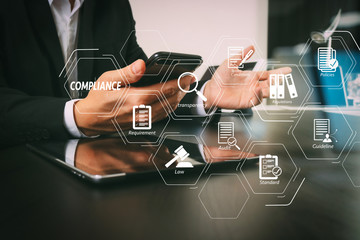 Poster - businessman working with smart phone and digital tablet and laptop computer in modern office with glass reflected view