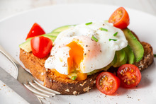 Healthy Breakfast With Avocado And Poached Egg Toast