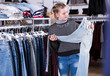 © JackF - Teen girl choosing jeans in store
