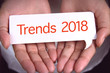 © dolphfyn - Trends 2018 wording on white talk bubble with hand.