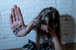 Pretty young girl showing the word stop written on her hand. Violence,abuse and bullying concept