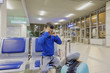 © Michael - Young boy sitting alone in a corridor of airport at feeling sad mood and crying