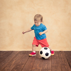 Wall Mural - Child is pretending to be a soccer player