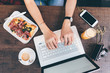© Eugenio Marongiu - overhead view woman hands using laptop computer - remote working, trading online, food blogger concept