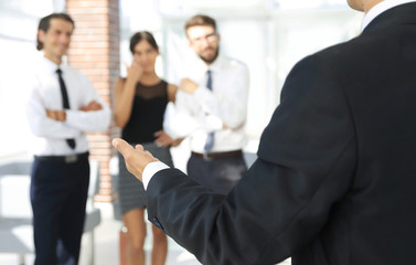 background image of businessman holding out hand for a handshake.