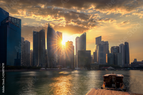 Obraz na plátne Evening sunset on Marina bay in Singapore city with wooded boat and waterfront