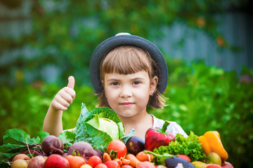 Child and  bio vegetables on the farm. Selective focus. 