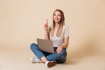 Sticker - Portrait of a cheerful casual girl with laptop computer