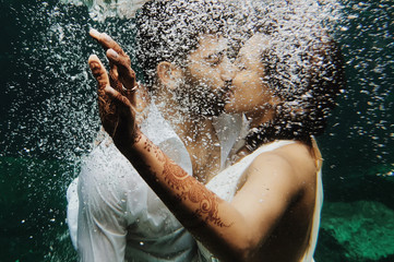 Wall Mural - Beautiful Indian couple kisses under the water