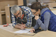 © goodluz - Wood industry technicians working together on project