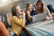 © goodluz - Friends connected on internet in coffeeshop
