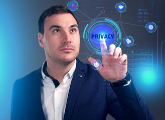 Business, Technology, Internet and network concept. Young businessman working on a virtual screen of the future and sees the inscription: Privacy