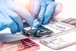 © TimeStopper - The abstract image of the technician assembling inside of smartphone by screwdriver in the lab. the concept of computer hardware, mobile phone, electronic, repairing, upgrade and technology.