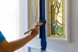 Fototapeta Tulipany - Female Hand holding paint brush Painting House Front Door