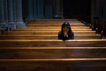 A Christian Girl Is Sitting And Praying With Broken Heart In The Church.