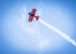 Red plane with propeller flying upward