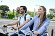 © W PRODUCTION - beautiful young couple riding a free rental bicycle in town during summer