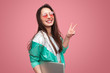 © kegfire - Hipster girl with laptop showing two fingers