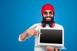 © kegfire - Bearded man pointing at laptop