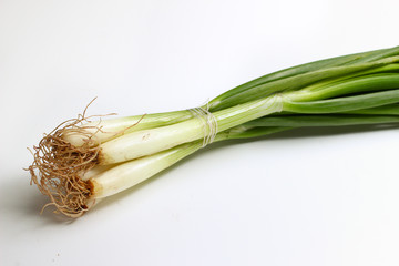 Wall Mural - Green onion on a white background