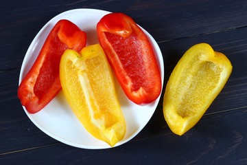 Poster - Sliced sweet pepper on a dark background