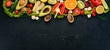 © Yaruniv-Studio - Healthy food. Vegetables and fruits On a black wooden background. Top view. Copy space.