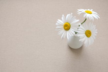 Linen Tablecloth And Chamomile Flowers In A Vase. Flat Lay, Top View, Copy Space 