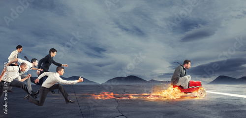 Photographie Fast businessman with a car wins against the competitors