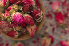 Dried Pink Rose Buds In A Brown Bowl