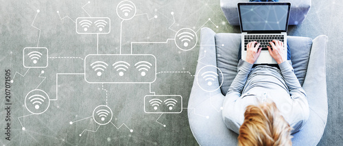 Fotografía WiFi with man using a laptop in a modern gray chair