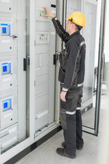Wall Mural - engineer commissioning bay control unit. engineering department