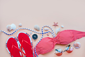 Wall Mural - Summer fashion flatlay with gradient round sunglasses, red flats and striped bikini top. Decorated with sea shells and compass. Perfect beach set for holidays on the sea. Marina style.