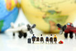© keatikun - Miniature people : Travelers with world globe and airplane , traveling or exploring the world, budget travel concepts.