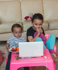 two little girls with laptop at home 