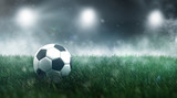 Fototapeta Sport - Soccer ball or football in a misty sports stadium